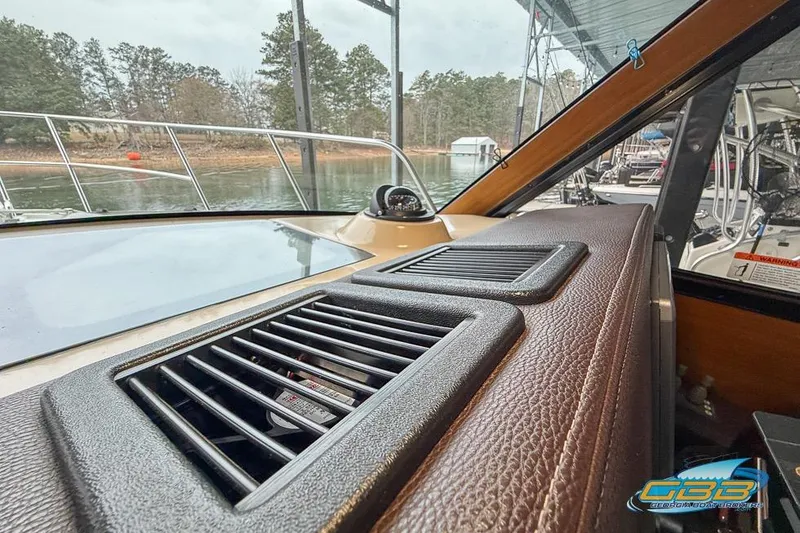 Slide: The Image of Interior view of 2013 Cutwater C-28 boat dashboard with lake in background. - 46