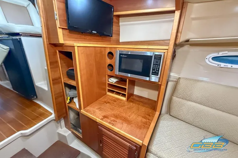 Slide: The Image of 2013 Cutwater C-28 interior with microwave, TV, and wooden cabinetry. - 21