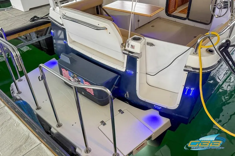 Slide: The Image of 2013 Cutwater C-28 boat with illuminated deck and American flag detail. - 76