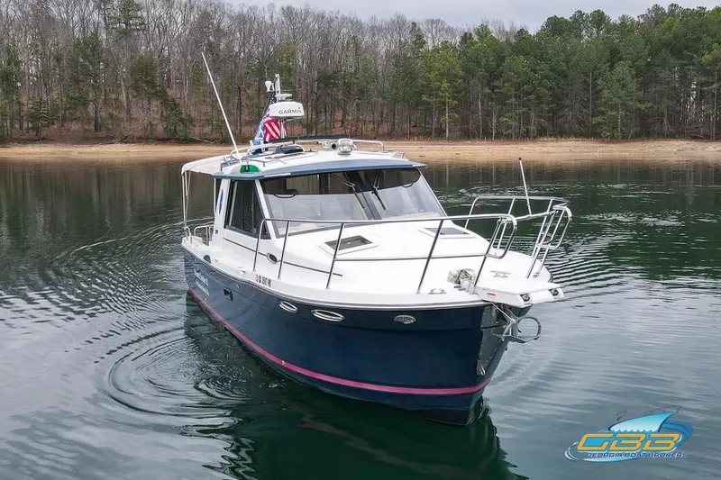 Slide: The Image of 2013 Cutwater C-28 boat on calm water with forested shoreline background. - 16