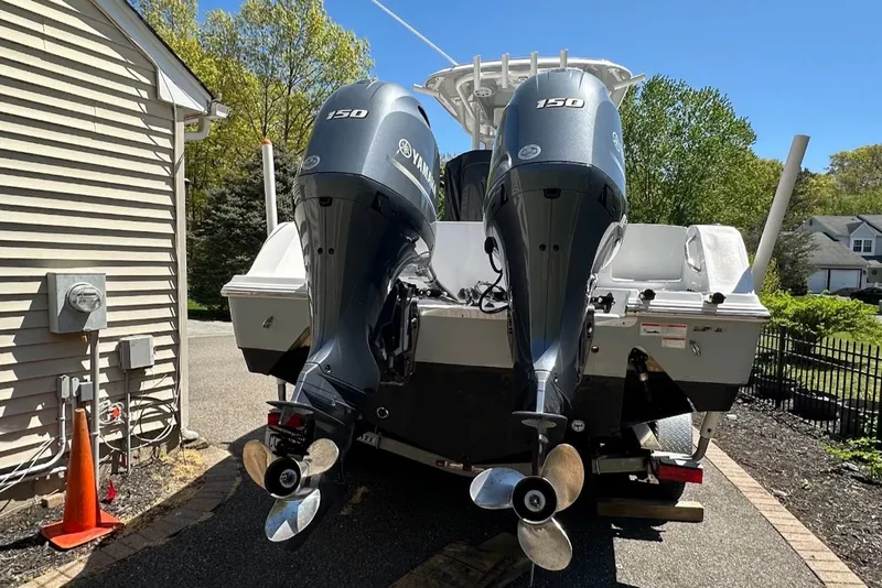 Slide: The Image of 2021 Sportsman Open 252 Center Console with twin Yamaha 150 engines in driveway. - 1