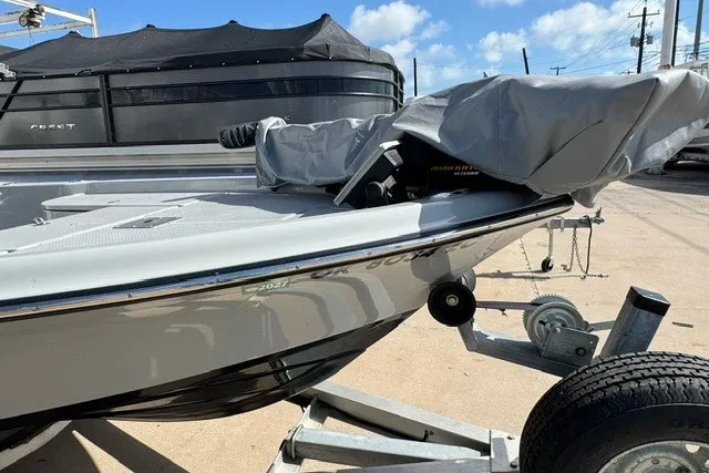 Slide: The Image of 2015 BLUEWAVE 2200 PURE boat on trailer, partially covered, sunny day. - 11