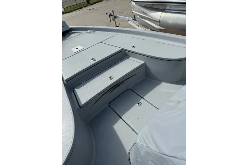 Slide: The Image of 2015 BLUEWAVE 2200 PURE boat deck with storage compartments and sleek design. - 18