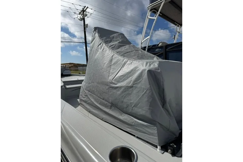 Slide: The Image of Covered 2015 BLUEWAVE 2200 PURE boat under a clear sky, showcasing protective tarp. - 15