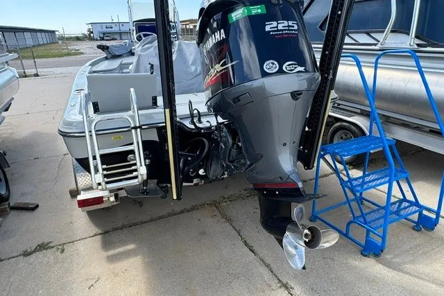 Slide: The Image of 2015 BLUEWAVE 2200 PURE boat with Yamaha 225 engine, docked with blue steps nearby. - 4
