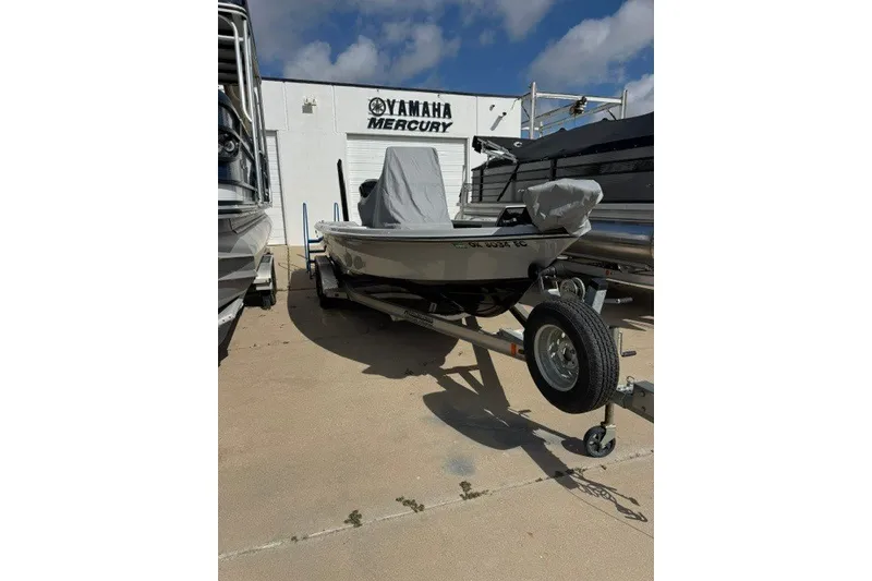 Slide: The Image of 2015 BLUEWAVE 2200 PURE boat on trailer, parked outside Yamaha Mercury dealership. - 13