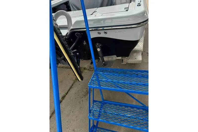 Slide: The Image of Blue metal stairs beside a 2015 BLUEWAVE 2200 PURE boat on concrete. - 19