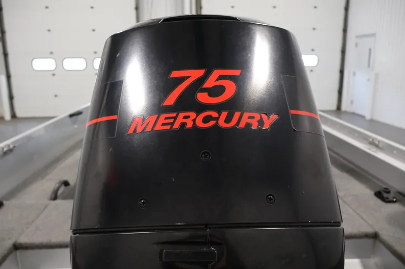 Slide: The Image of 2004 Alumacraft Navigator 165 CS with 75 Mercury outboard motor in a garage. - 40