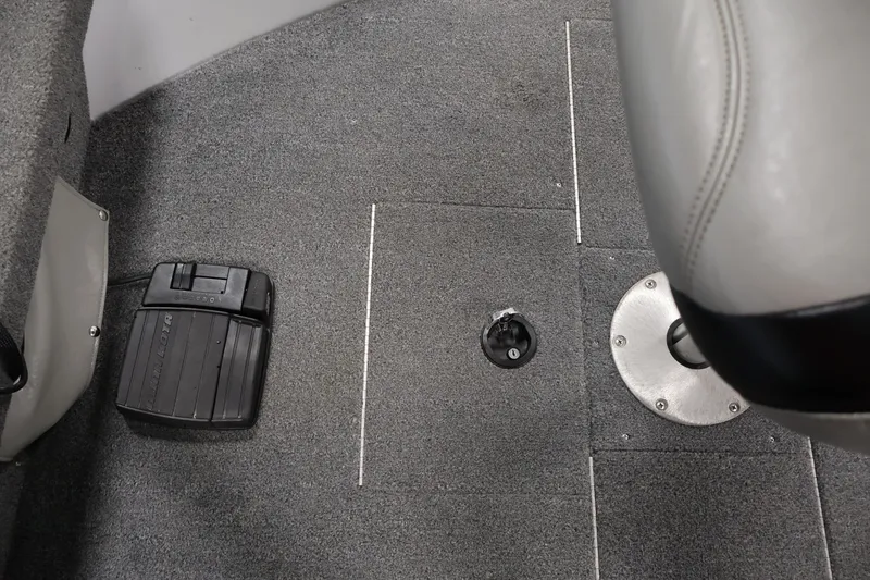 Slide: The Image of 2004 Alumacraft Navigator 165 CS boat interior with foot pedal and seat base. - 15