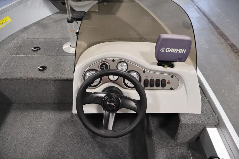 Slide: The Image of 2004 Alumacraft Navigator 165 CS boat dashboard with Garmin GPS and steering wheel. - 23
