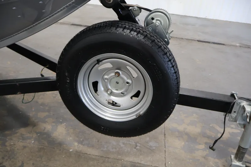 Slide: The Image of Trailer wheel of 2004 Alumacraft Navigator 165 CS boat on concrete floor. - 43