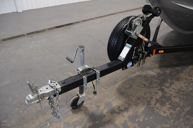Slide: The Image of Trailer hitch of 2004 Alumacraft Navigator 165 CS boat, featuring a sturdy wheel and winch. - 42