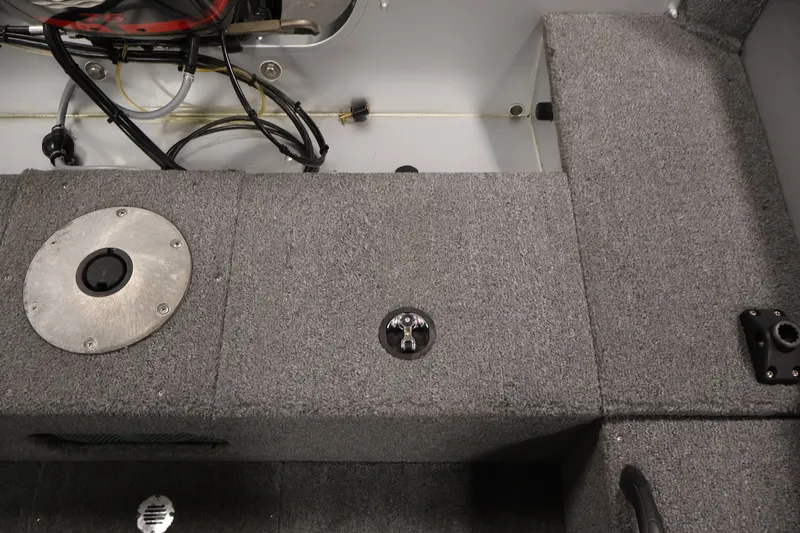Slide: The Image of 2004 Alumacraft Navigator 165 CS boat interior with gray carpet and wiring. - 35