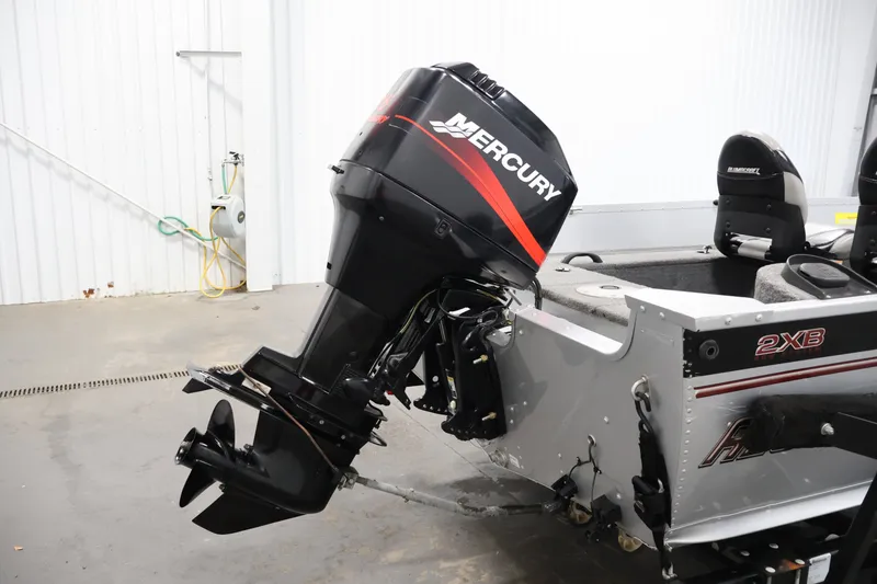 Slide: The Image of 2004 Alumacraft Navigator 165 CS boat with Mercury outboard motor in a garage. - 38