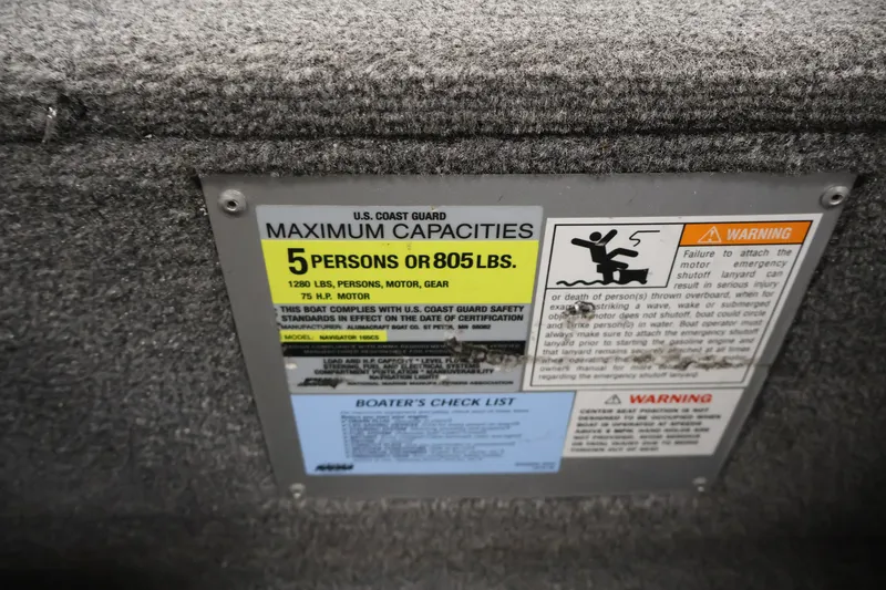 Slide: The Image of 2004 Alumacraft Navigator 165 CS capacity label, maximum 5 persons or 805 lbs, safety warnings. - 37