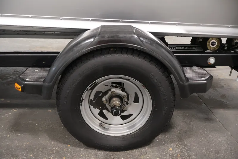 Slide: The Image of Trailer wheel of 2004 Alumacraft Navigator 165 CS boat, featuring Goodyear tire. - 45
