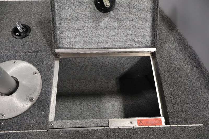 Slide: The Image of Open storage compartment on 2004 Alumacraft Navigator 165 CS boat deck. - 18