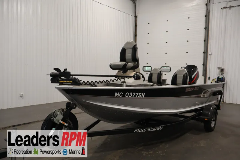 The Image of 2004 Alumacraft Navigator 165 CS boat on trailer in indoor showroom. - 1