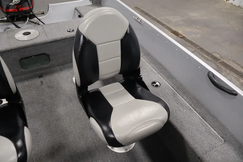 Slide: The Image of 2004 Alumacraft Navigator 165 CS boat seat, black and gray upholstery, interior view. - 30