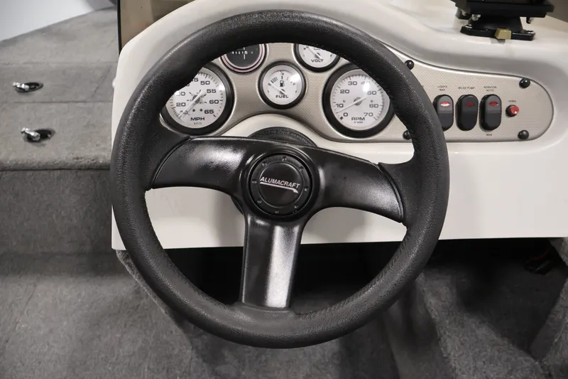 Slide: The Image of Steering wheel and dashboard of 2004 Alumacraft Navigator 165 CS boat. - 24