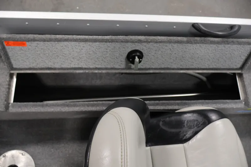 Slide: The Image of 2004 Alumacraft Navigator 165 CS boat interior with storage compartment and seat. - 31