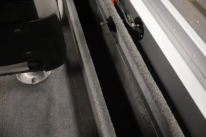 Slide: The Image of Interior view of 2004 Alumacraft Navigator 165 CS boat, showing seating and storage compartment. - 32