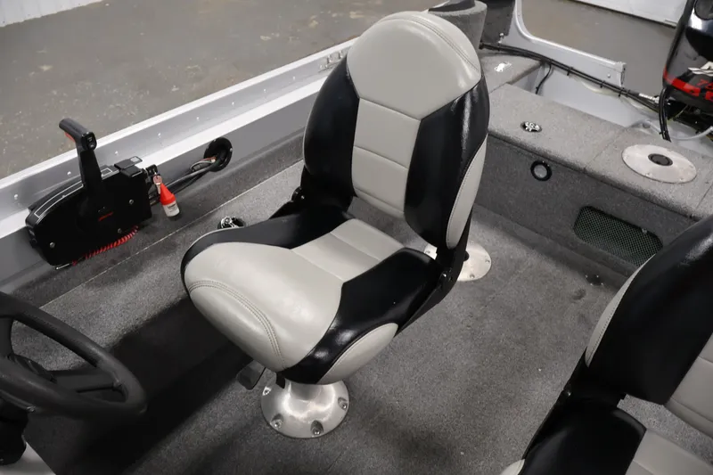 Slide: The Image of 2004 Alumacraft Navigator 165 CS boat interior with black and white seating. - 29