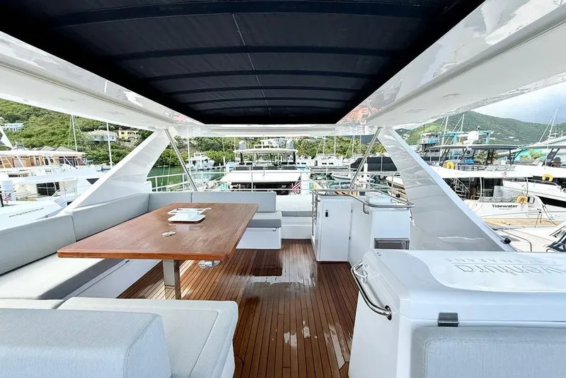 Slide: The Image of Luxurious 2026 Aventura 56 Motor Yacht deck with seating and dining area. - 23