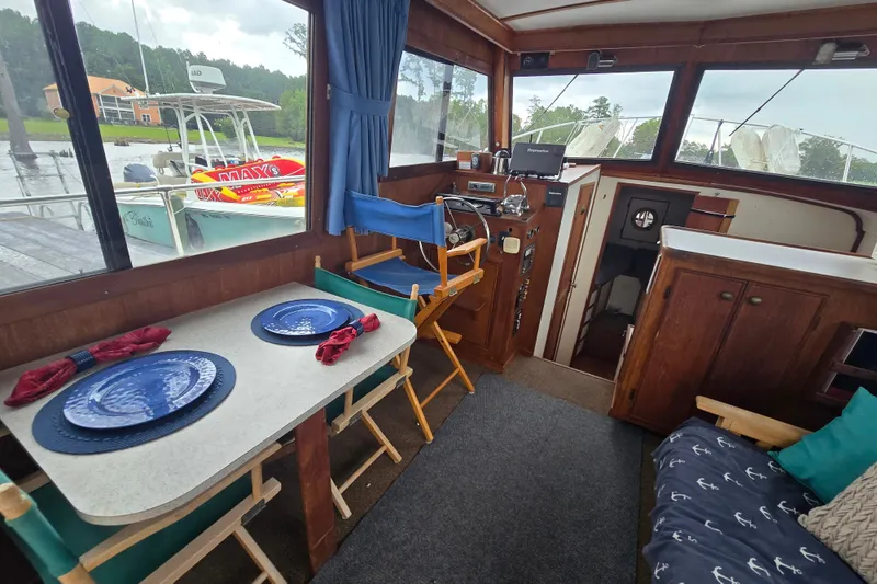 Slide: The Image of Interior of 1983 Atlantic 30 LRC boat with dining area and helm. - 28