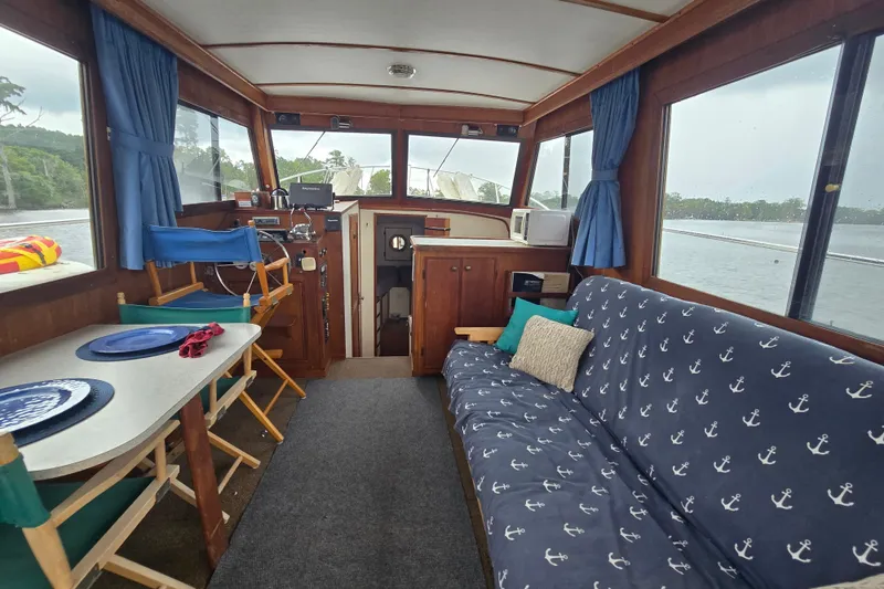 Slide: The Image of Interior of a 1983 Atlantic 30 LRC boat with nautical-themed decor. - 9