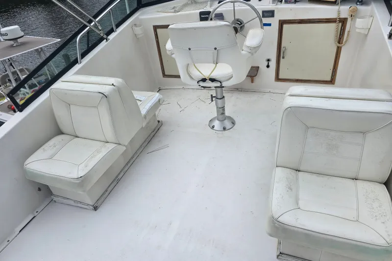 Slide: The Image of 1983 Atlantic 30 LRC boat interior with white seating and steering wheel. - 6