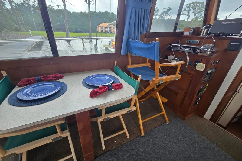 Slide: The Image of Interior of 1983 Atlantic 30 LRC boat with dining setup and helm station. - 11