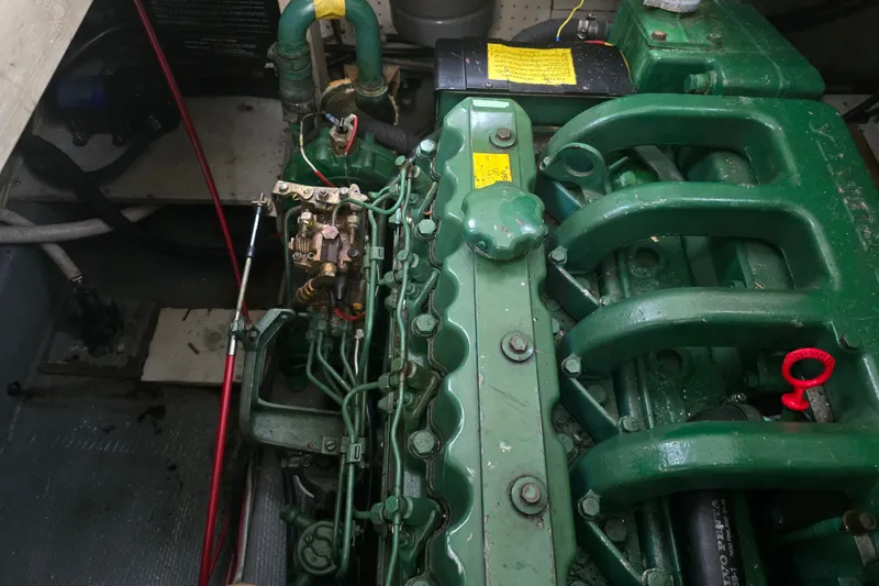 Slide: The Image of Engine compartment of a 1983 Atlantic 30 LRC boat, showcasing green machinery components. - 20