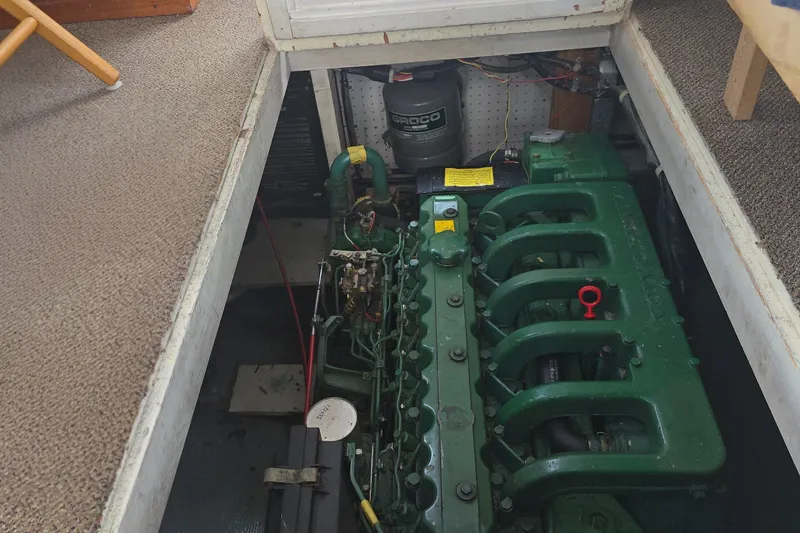 Slide: The Image of Engine compartment of a 1983 Atlantic 30 LRC boat, featuring a green engine. - 18