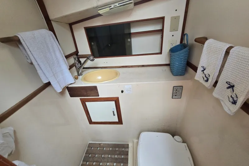 Slide: The Image of Bathroom interior of 1983 Atlantic 30 LRC boat with sink, mirror, and towels. - 16