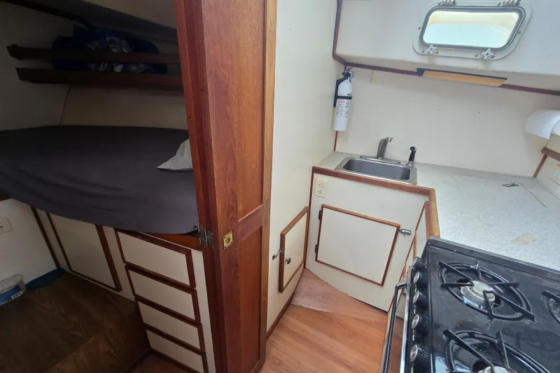 Slide: The Image of Interior of a 1983 Atlantic 30 LRC boat showing kitchen and sleeping area. - 14
