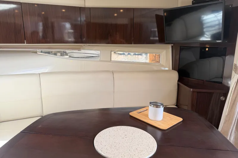 Slide: The Image of Interior of 2015 Sea Ray 370 Venture yacht with elegant seating and mounted TV. - 44