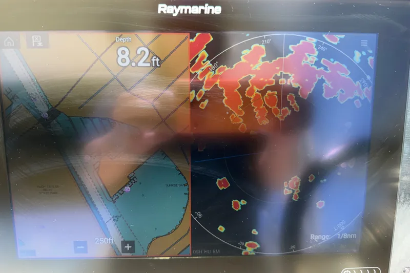 Slide: The Image of Raymarine navigation display showing depth and radar on a 2015 Sea Ray 370 Venture. - 33
