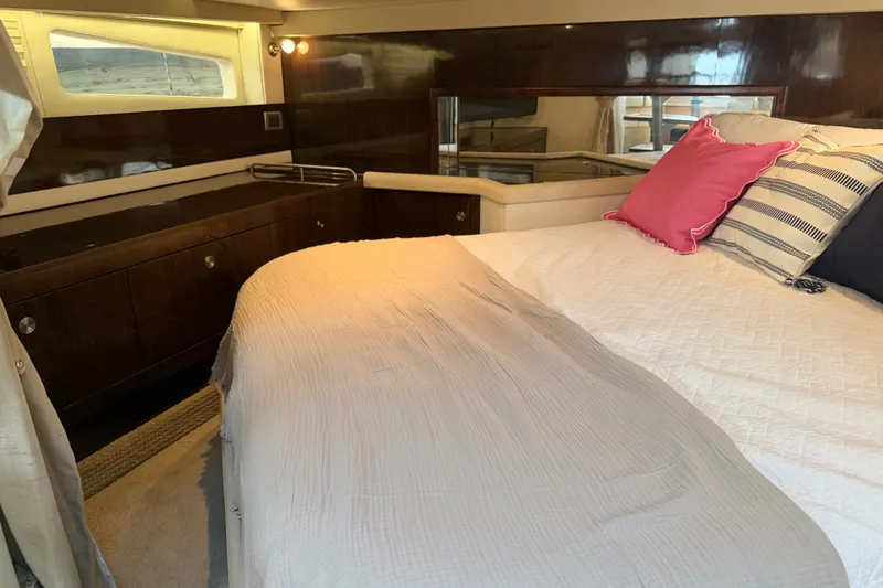 Slide: The Image of Luxurious cabin interior of 2015 Sea Ray 370 Venture with elegant bedding and wood finishes. - 49