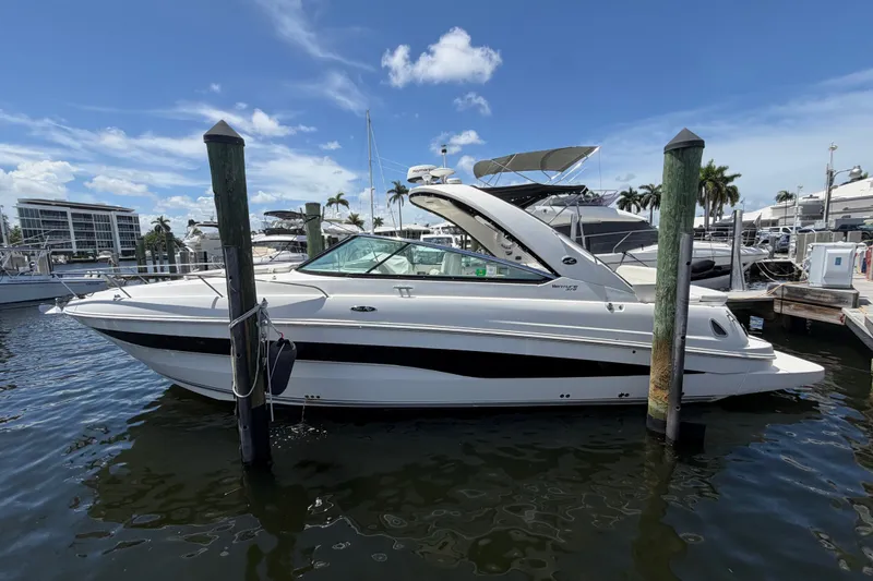 Slide: The Image of 2015 Sea Ray 370 Venture yacht docked at marina under clear blue sky. - 14