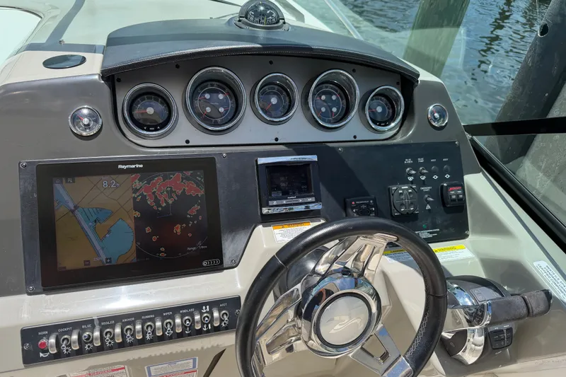 Slide: The Image of Cockpit of 2015 Sea Ray 370 Venture with navigation system and control panel. - 32