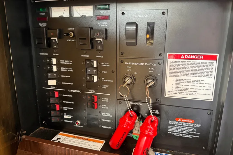 Slide: The Image of Electrical control panel of a 2015 Sea Ray 370 Venture boat with ignition keys. - 45