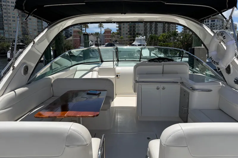 Slide: The Image of Luxurious 2015 Sea Ray 370 Venture yacht interior with white seating and wooden table. - 18