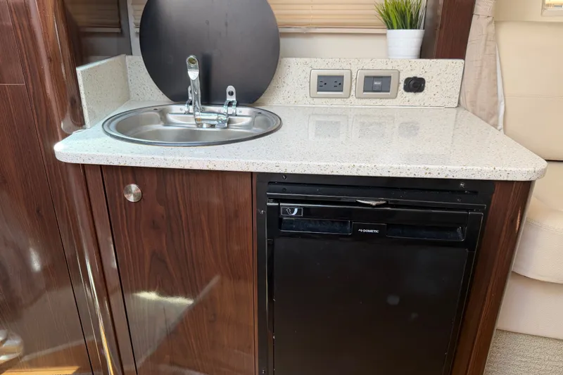 Slide: The Image of Compact kitchenette in 2015 Sea Ray 370 Venture with sink, countertop, and mini fridge. - 43