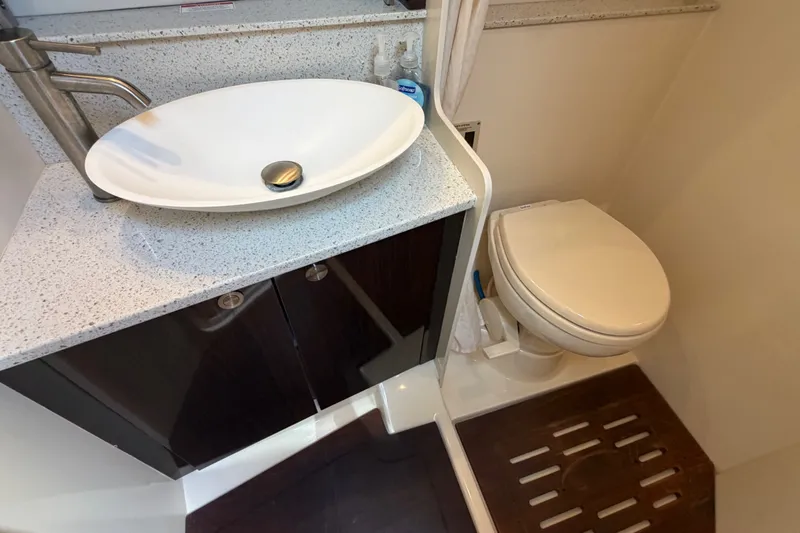 Slide: The Image of 2015 Sea Ray 370 Venture bathroom with modern sink and toilet. - 41