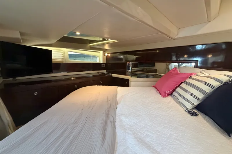 Slide: The Image of Luxurious interior cabin of 2015 Sea Ray 370 Venture yacht with cozy bedding and modern amenities. - 51