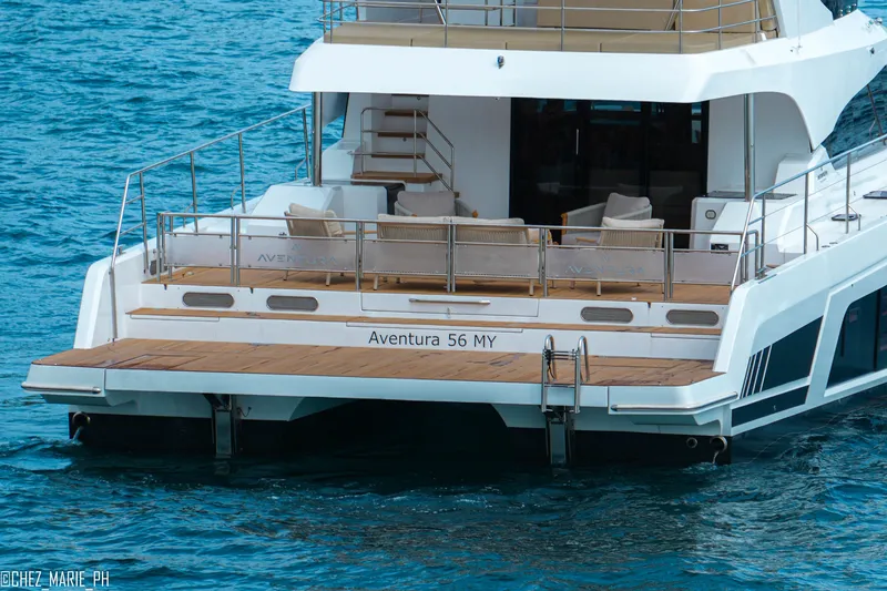 Slide: The Image of Aventura 56 Motor Yacht 2026, elegant design, cruising on blue ocean waters. - 1