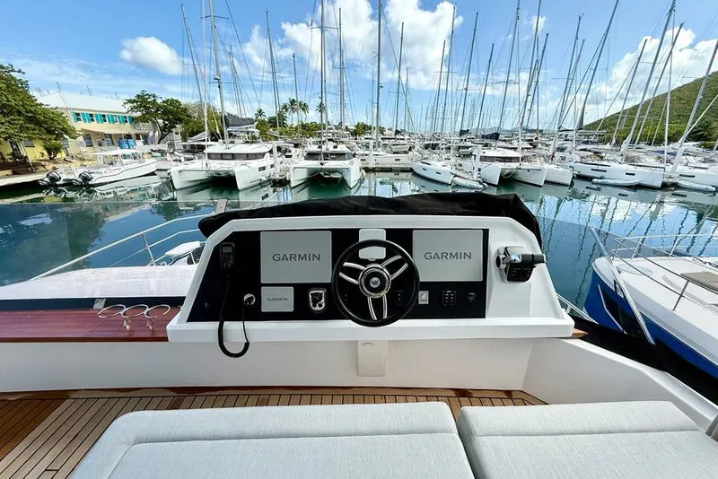 Slide: The Image of Helm of 2026 Aventura 56 Motor Yacht in marina, featuring Garmin navigation systems. - 19