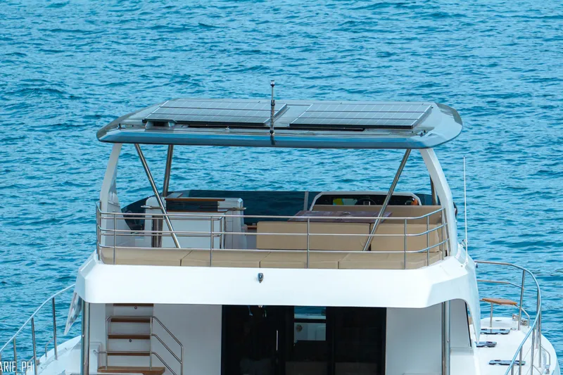 Slide: The Image of Aventura 56 Motor Yacht 2026 with solar panels on deck, cruising in blue waters. - 5