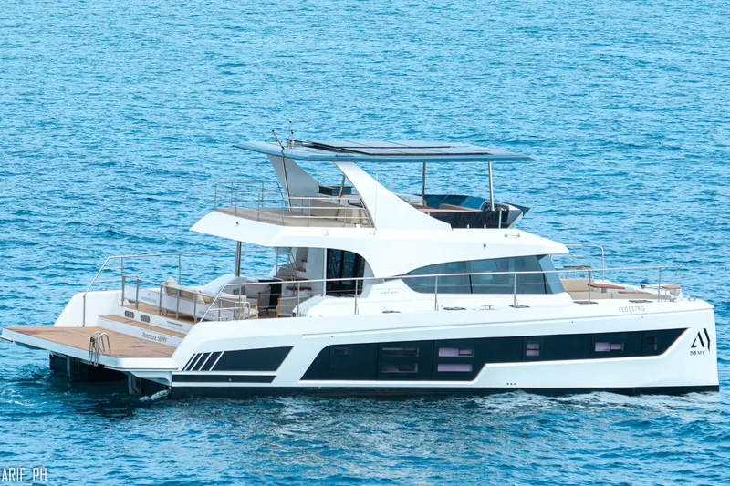 Slide: The Image of Aventura 56 Motor Yacht 2026 cruising on clear blue waters. - 4
